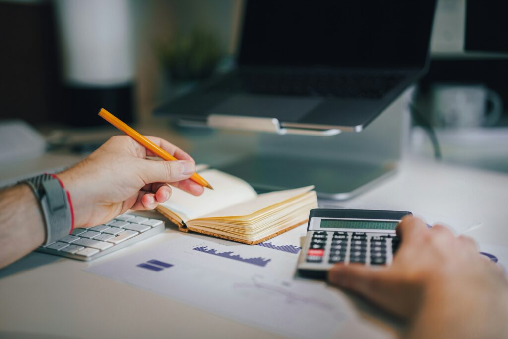 Person analyzing credit score reports and financial planning